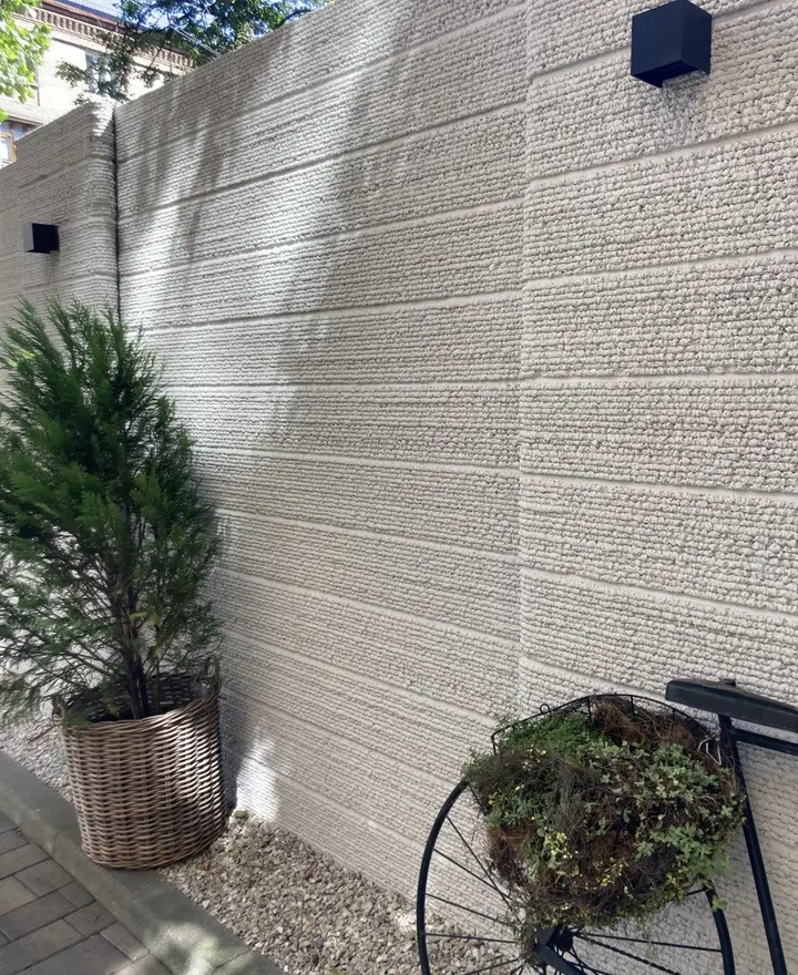 Surface texture: the printed layers are visible and tactile, so the wall needs no cladding.